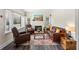 Inviting living room with hardwood floors, fireplace, and comfortable leather furniture at 1601 E 1St Ave, Mount Dora, FL 32757