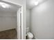 Bathroom featuring a toilet and an open door to a walk-in closet with wire shelving at 1613 Reflection Cv, St Cloud, FL 34771