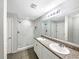 Bright bathroom featuring a double sink vanity, a large mirror and a seamless glass shower at 1613 Reflection Cv, St Cloud, FL 34771