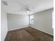 Neutral bedroom offers a clean space with ceiling fan, carpet and a bright window at 1613 Reflection Cv, St Cloud, FL 34771