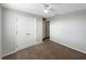 Bedroom with ceiling fan, closet with double doors, and adjacent bathroom at 1613 Reflection Cv, St Cloud, FL 34771