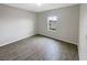 This bedroom has hardwood floors and natural light from the window at 1613 Reflection Cv, St Cloud, FL 34771