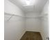 A walk-in closet with wire shelving and neutral carpet at 1613 Reflection Cv, St Cloud, FL 34771
