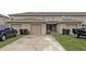 Townhouse with a two-car garage and driveway, plus additional parking on the side at 1613 Reflection Cv, St Cloud, FL 34771