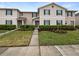 Inviting townhouse exterior boasts manicured landscaping, a concrete walkway and beautiful green shutters at 1613 Reflection Cv, St Cloud, FL 34771