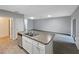 This kitchen features an island with sink and an adjacent living room at 1613 Reflection Cv, St Cloud, FL 34771