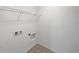 A small laundry room area with shelving and washer/dryer hookups at 1613 Reflection Cv, St Cloud, FL 34771