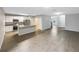 Spacious living area with modern gray walls, light tile floors and an open kitchen at 1613 Reflection Cv, St Cloud, FL 34771