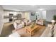 Bright living room open to kitchen, featuring modern furniture, wood floors, and plenty of natural light at 1613 Reflection Cv, St Cloud, FL 34771