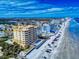 Aerial view of a beachfront condo offering stunning ocean views and beach access, near local amenities at 1705 S Atlantic Ave # 402, New Smyrna Beach, FL 32169
