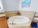 Tranquil bathroom featuring a luxurious soaking tub and coastal-inspired accents at 1705 S Atlantic Ave # 402, New Smyrna Beach, FL 32169