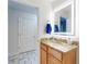Bright bathroom featuring granite countertop vanity and illuminated mirror at 1705 S Atlantic Ave # 402, New Smyrna Beach, FL 32169