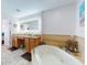 Well-appointed bathroom with double sinks, a soaking tub, and beach-themed decor at 1705 S Atlantic Ave # 402, New Smyrna Beach, FL 32169