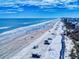 Stunning aerial image of a beautiful beach, highlighting its serene coastline and ocean at 1705 S Atlantic Ave # 402, New Smyrna Beach, FL 32169