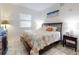 Inviting bedroom with a large bed, coastal-themed decor, and a bright window at 1705 S Atlantic Ave # 402, New Smyrna Beach, FL 32169