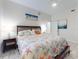 This bedroom features a ceiling fan, seaside art, and tiled floors at 1705 S Atlantic Ave # 402, New Smyrna Beach, FL 32169