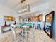 Inviting dining space with ocean views and a modern light fixture that enhances the open-concept living at 1705 S Atlantic Ave # 402, New Smyrna Beach, FL 32169