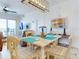 Bright dining room with a modern light fixture, cozy seating, and a view of the ocean, creates a welcoming space at 1705 S Atlantic Ave # 402, New Smyrna Beach, FL 32169