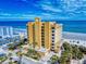 Beautiful building with manicured lawns, palm trees, and ocean view creates a serene resort-like atmosphere at 1705 S Atlantic Ave # 402, New Smyrna Beach, FL 32169