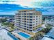 A nice aerial view of a building with balconies, a pool, and a hot tub at 1705 S Atlantic Ave # 402, New Smyrna Beach, FL 32169