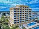 A nice aerial view of a condo building, showing its balconies, pool, and hot tub at 1705 S Atlantic Ave # 402, New Smyrna Beach, FL 32169