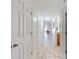Bright hallway features tiled flooring, white trim, and access to multiple rooms at 1705 S Atlantic Ave # 402, New Smyrna Beach, FL 32169