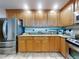 Well-lit kitchen featuring stainless steel appliances, granite countertops, and tile flooring at 1705 S Atlantic Ave # 402, New Smyrna Beach, FL 32169