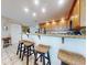 Bright kitchen featuring modern appliances, granite countertops, and bar seating under recessed lighting at 1705 S Atlantic Ave # 402, New Smyrna Beach, FL 32169