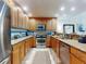Spacious kitchen with stainless steel appliances, granite countertops, and a stylish backsplash at 1705 S Atlantic Ave # 402, New Smyrna Beach, FL 32169
