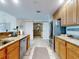 Modern kitchen with stainless steel appliances, granite countertops, and adjacent living area at 1705 S Atlantic Ave # 402, New Smyrna Beach, FL 32169