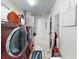Spacious laundry room with side-by-side washer and dryer leading to hallway and additional storage at 1705 S Atlantic Ave # 402, New Smyrna Beach, FL 32169