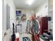 Well-organized laundry room featuring a full-size washer and dryer set, shelving, and mini refrigerator at 1705 S Atlantic Ave # 402, New Smyrna Beach, FL 32169