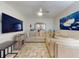 Inviting living room with comfortable seating, decorative pillows, ceiling fan, and a modern television set at 1705 S Atlantic Ave # 402, New Smyrna Beach, FL 32169