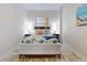 Bright bedroom featuring a white frame bed with coastal-themed bedding and matching decor for a tranquil vibe at 1705 S Atlantic Ave # 402, New Smyrna Beach, FL 32169