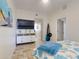 Comfortable bedroom with TV and dresser and stylish decor, a relaxing retreat with beach-themed art and details at 1705 S Atlantic Ave # 402, New Smyrna Beach, FL 32169