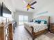 Serene main bedroom with a comfortable bed, ceiling fan, and sliding glass doors to ocean view balcony at 1705 S Atlantic Ave # 402, New Smyrna Beach, FL 32169