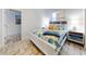 Charming bedroom with a coastal theme, showcasing the bed, side tables, and unique tile flooring detail at 1705 S Atlantic Ave # 402, New Smyrna Beach, FL 32169