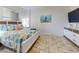 Coastal-themed bedroom with a comfortable bed, a flat-screen TV, and stylish decor creates a relaxing retreat at 1705 S Atlantic Ave # 402, New Smyrna Beach, FL 32169