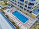 Overhead shot of a pool and lounge chairs at a beachfront condo community at 1705 S Atlantic Ave # 402, New Smyrna Beach, FL 32169