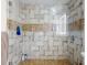 Elegant walk-in shower featuring unique tile work, glass door, and recessed niche for toiletries at 1705 S Atlantic Ave # 402, New Smyrna Beach, FL 32169
