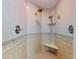 Contemporary shower with multiple showerheads, a built-in seat, and tiled walls at 1705 S Atlantic Ave # 402, New Smyrna Beach, FL 32169