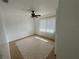 Neutral bedroom with tile flooring, ceiling fan, and ample natural light from the large window at 1826 Giles St, Deltona, FL 32725