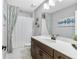 Modern bathroom with a large mirror, sleek vanity, and a pristine shower and tub combo at 1856 Cross Prairie Pkwy, Kissimmee, FL 34744