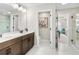 Bathroom features a double sink vanity, white tile flooring and doorway access to other rooms at 1856 Cross Prairie Pkwy, Kissimmee, FL 34744