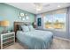 Relaxing bedroom with ocean-themed decor, a comfy bed, and a bright window view at 1856 Cross Prairie Pkwy, Kissimmee, FL 34744