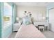 Charming bedroom with a pastel palette, including a comfortable bed, bedside table, and desk area at 1856 Cross Prairie Pkwy, Kissimmee, FL 34744