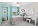 Inviting bedroom features a full bed, a stylish desk, and soft, natural light from the nearby window at 1856 Cross Prairie Pkwy, Kissimmee, FL 34744