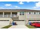 Charming townhome featuring a two-car garage, neutral paint, and a second-story balcony at 1856 Cross Prairie Pkwy, Kissimmee, FL 34744