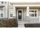 Inviting front porch with stone accents on the pillars and a covered entrance to the home at 1856 Cross Prairie Pkwy, Kissimmee, FL 34744