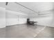 Organized two-car garage featuring epoxy flooring, a storage shelf, and a ping pong table at 1856 Cross Prairie Pkwy, Kissimmee, FL 34744